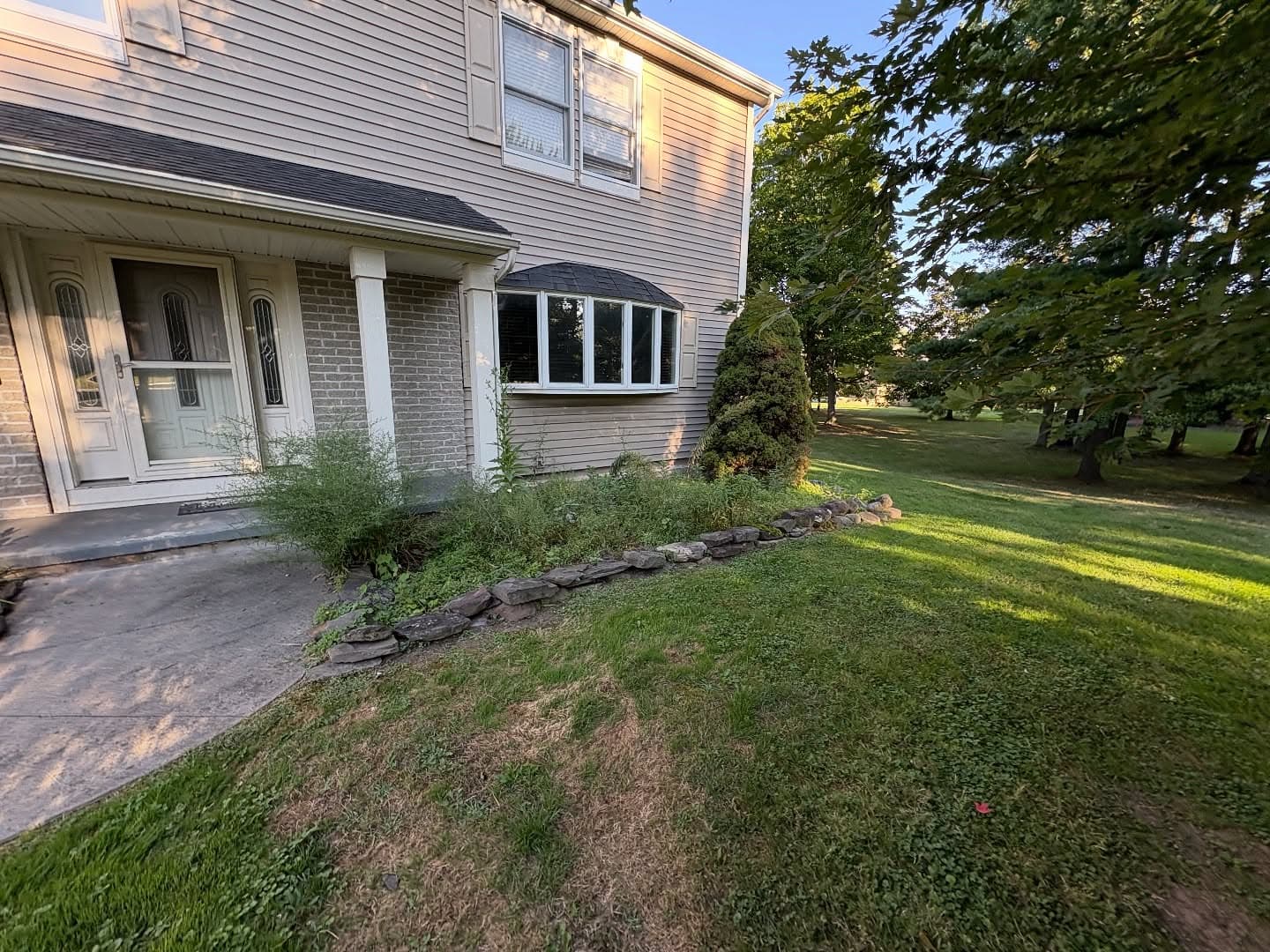 Before - overgrown landscaping needing renovation